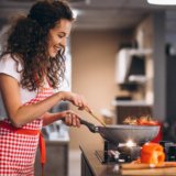 woman-chef-cooking-vegetables-in-pan